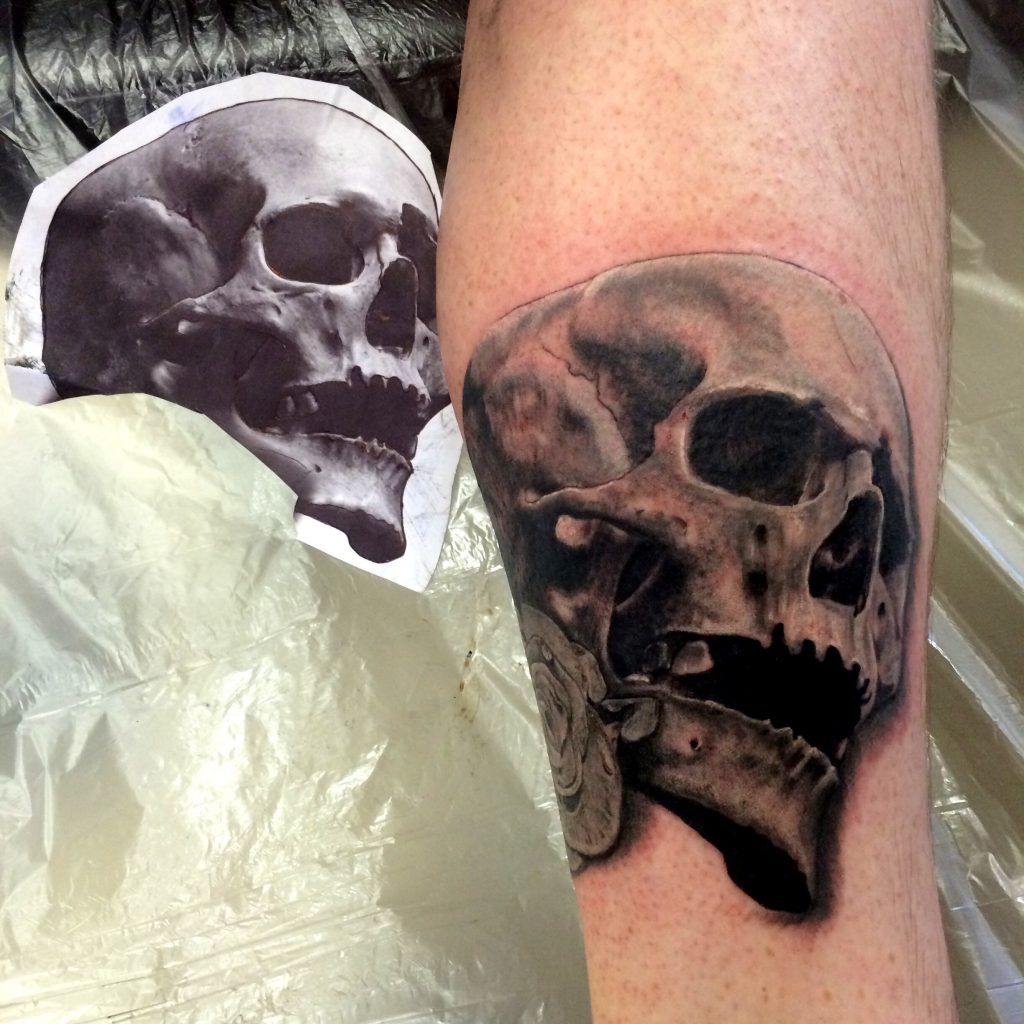 Black Skull by Spiro at Artistic Impressions Tattoo Studio located in Katy, Texas