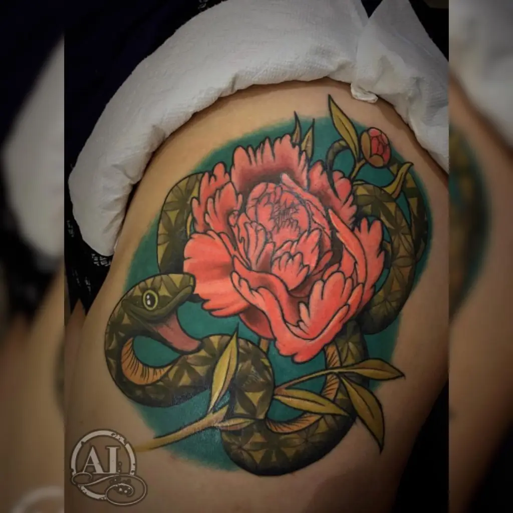 Snake and flower by Spiro at Artistic Impressions Tattoo Studio located in Katy, Texas