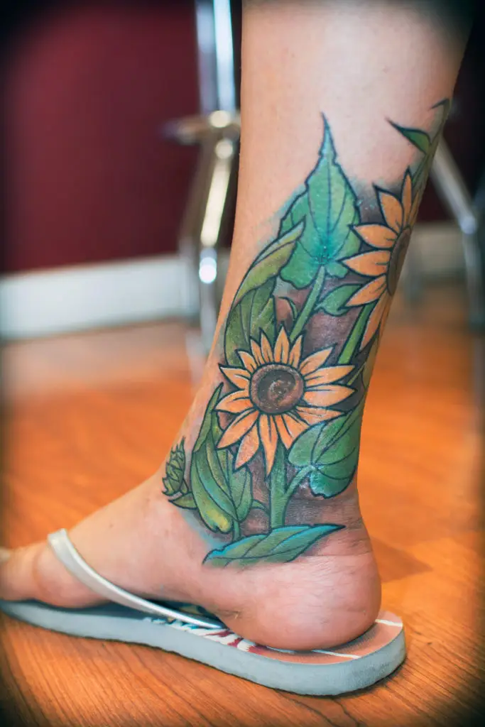 Sunflower on Calf by Spiro at Artistic Impressions Tattoo Studio located in Katy, Texas