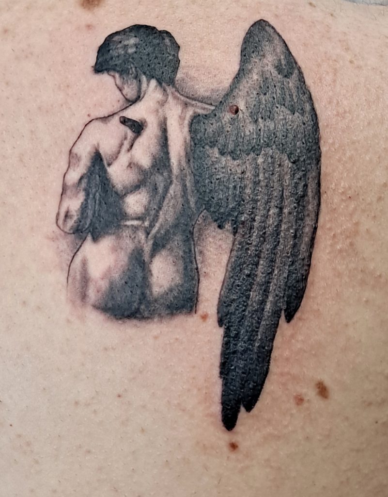 a tattoo of an angel by Mike at Artistic Impressions Tattoo Studio in Katy, Texas