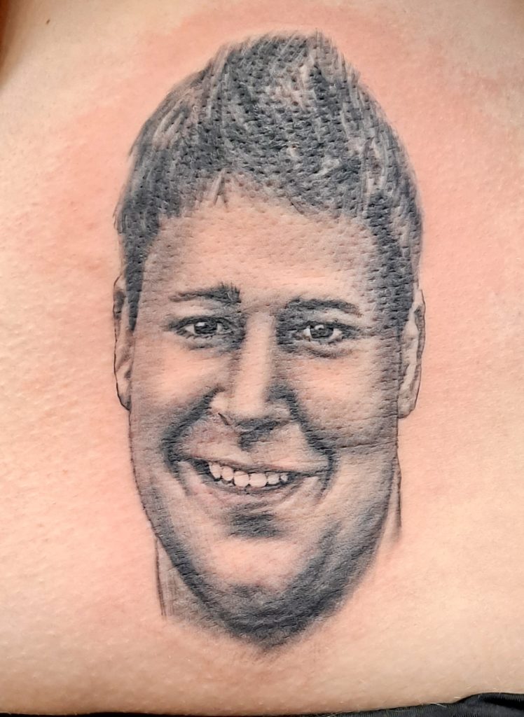 a tattoo of a portrait by Mike at Artistic Impressions Tattoo Studio in Katy, Texas