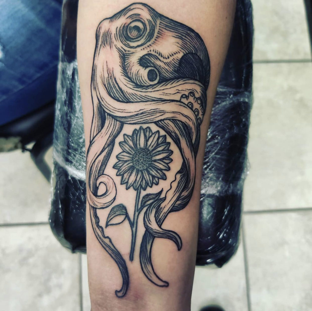 a tattoo of an Octopus and flower by Mark Anthony at Artistic Impressions Tattoo Studio in Katy, Texas