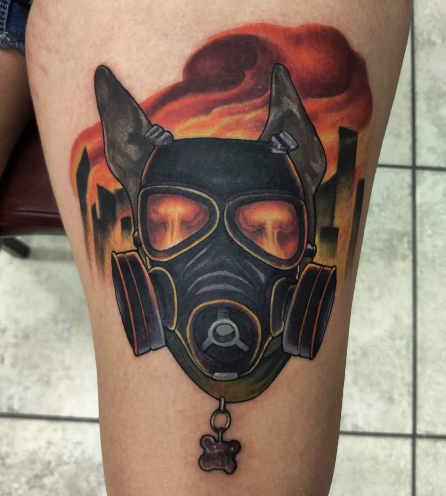 a tattoo of a mask by Mark at Artistic Impressions Tattoo Studio in Katy, Texas