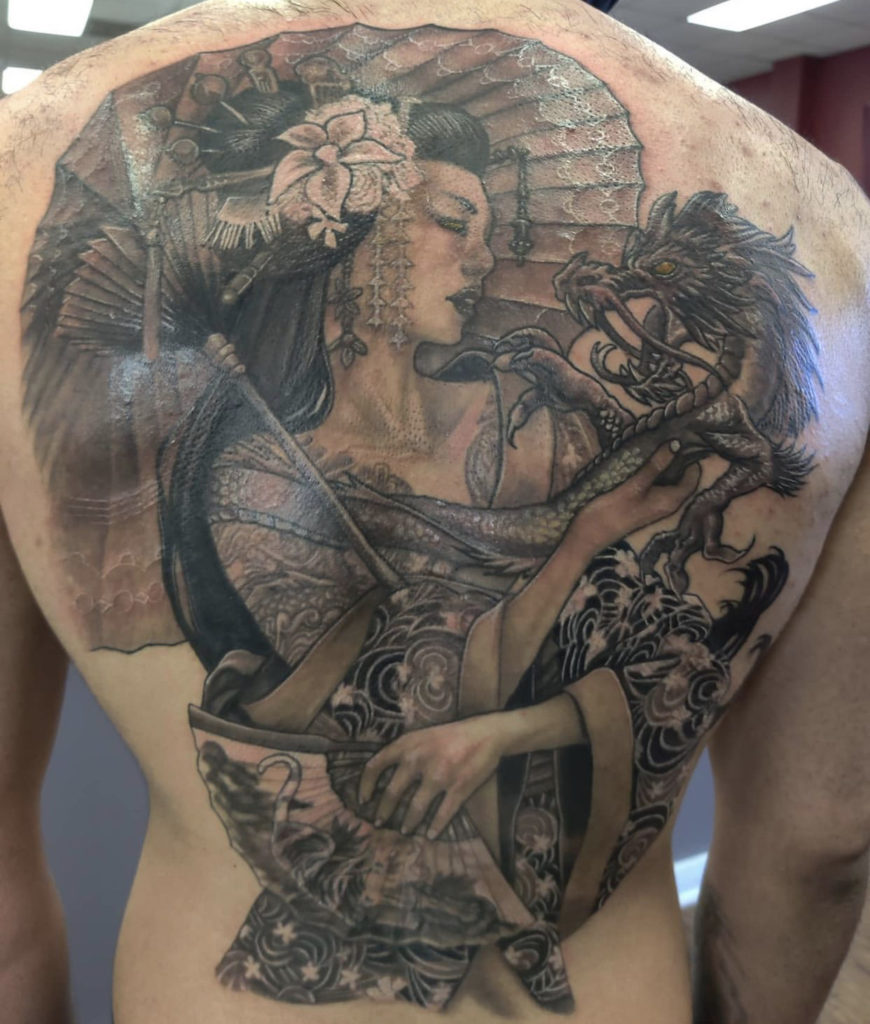 a tattoo back piece of a Geisha with a dragon and umbrella by Mark Anthony at Artistic Impressions Tattoo Studio in Katy, texas