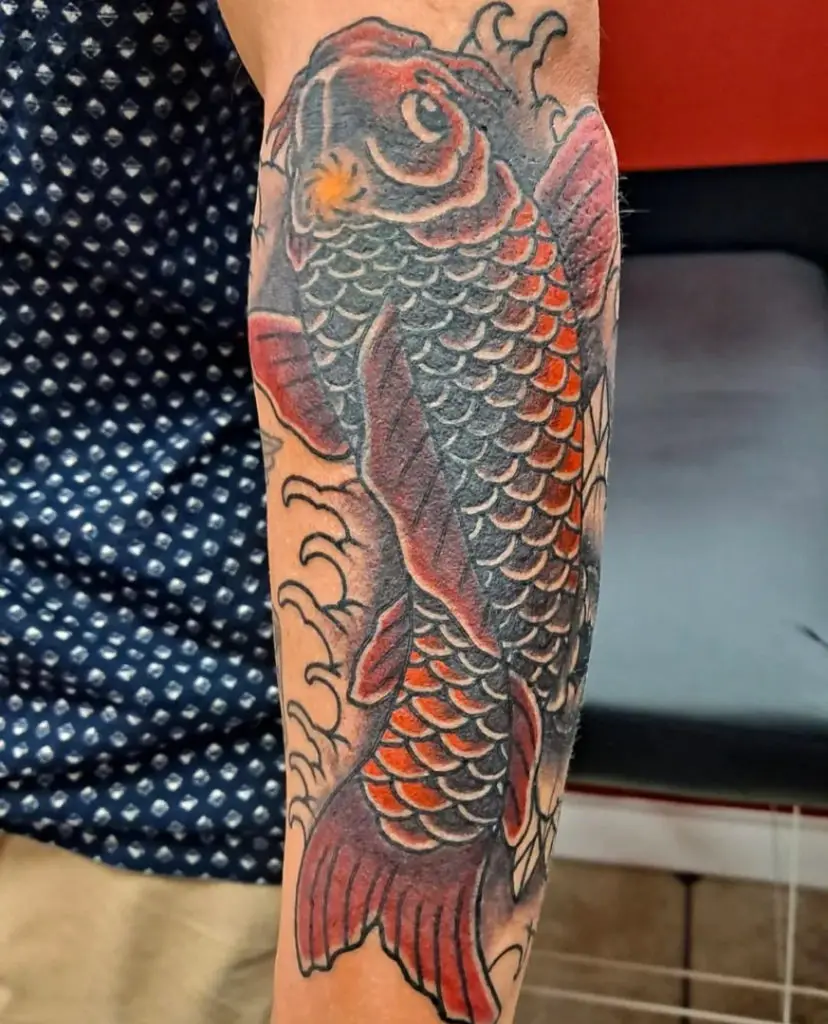 a tattoo of a Japanese Koi fish tattoo by Mike Valadez at Artistic Impressions Tattoo Studio in Katy, Texas