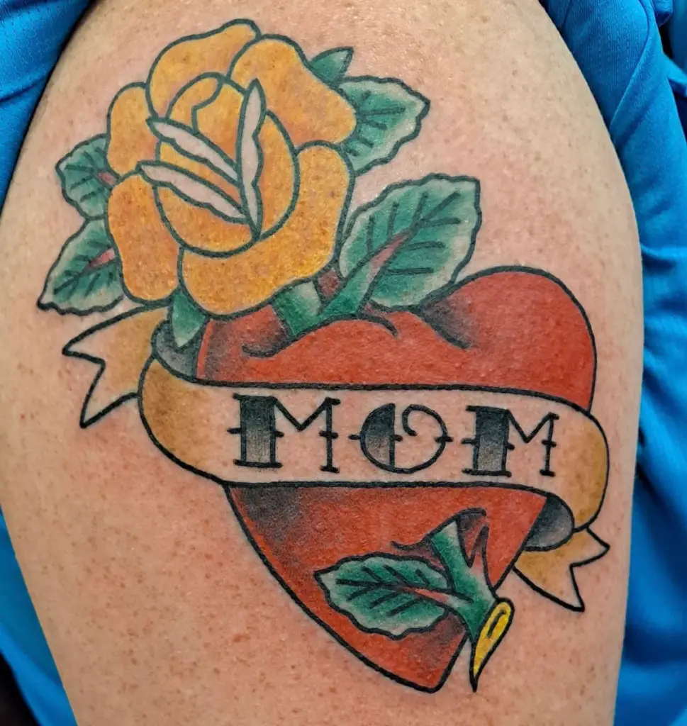 a traditional tattoo of a heart with a banner by Mike Valadez at Artistic Impressions Tattoo Studio in Katy, Texas