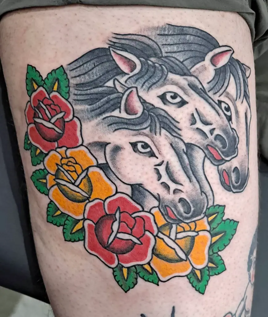 a traditional tattoo of horses with roses by Mike Valadez at Artistic Impressions Tattoo Studio in Katy, Texas