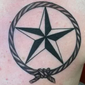 a tattoo of a lonestar in black by Ulisses at Artistic Impressions Tattoo Studio in Katy, Texas