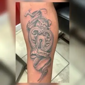 a tattoo of a heart lock and key with lettering by Ulisses at Artistic Impressions Tattoo Studio in Katy, Texas