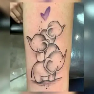 a tattoo of cartoon elephant sitting on eachother with a purple heart above by Ulisses at Artistic Impressions Tattoo Studio in Katy, Texas