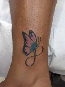 a tattoo of a butterfly with and infinity symbol