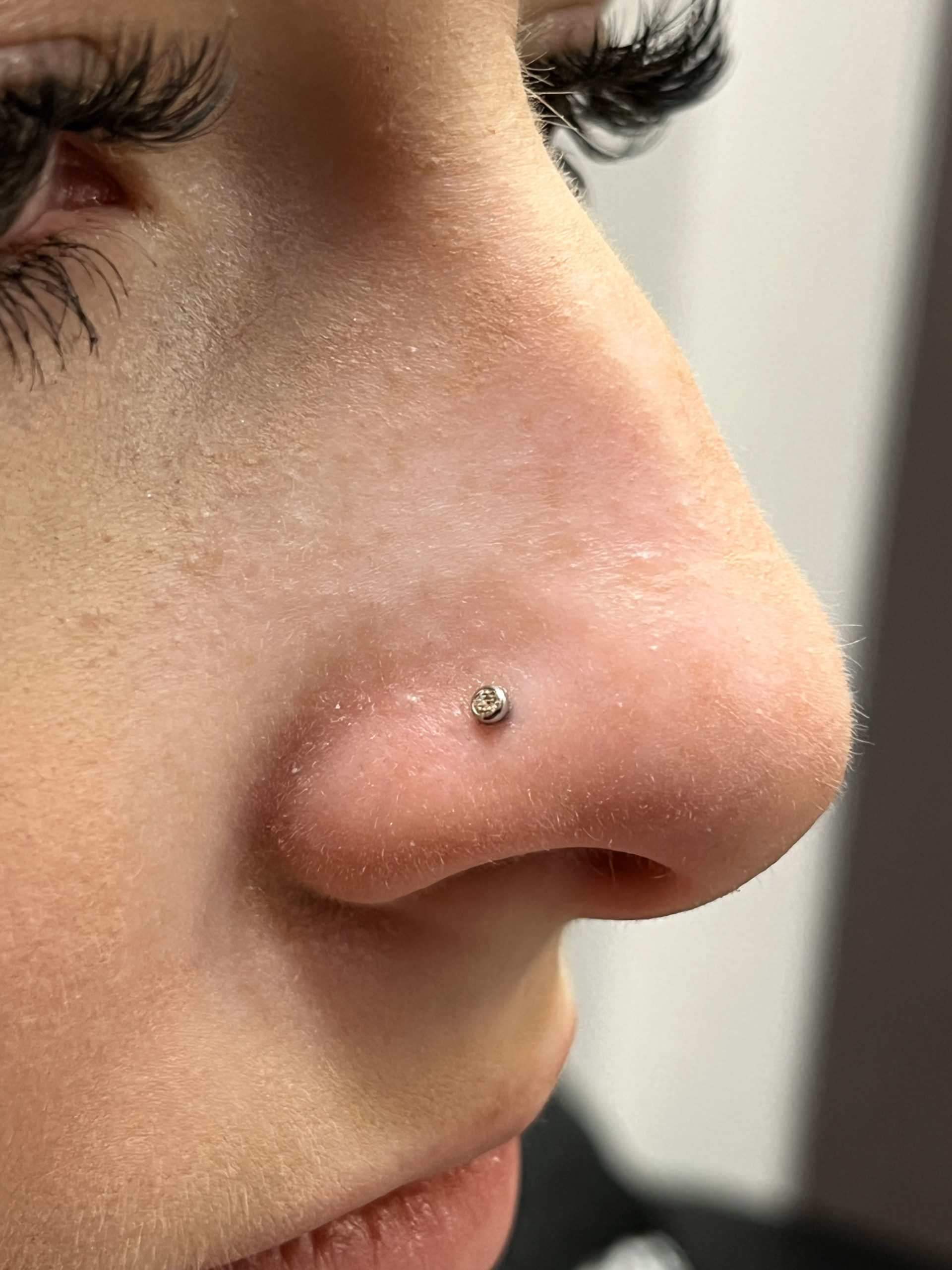 Nostril piercings by Cadin Rose at Artistic Impressions Tattoo Studio located in Katy Texas