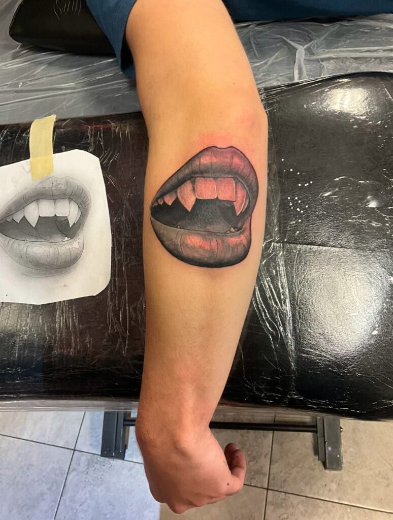 Vampire lips tattooed by Colton at the best tattoo shop in Katy, Texas at Artistic Impressions Tattoo Studio.