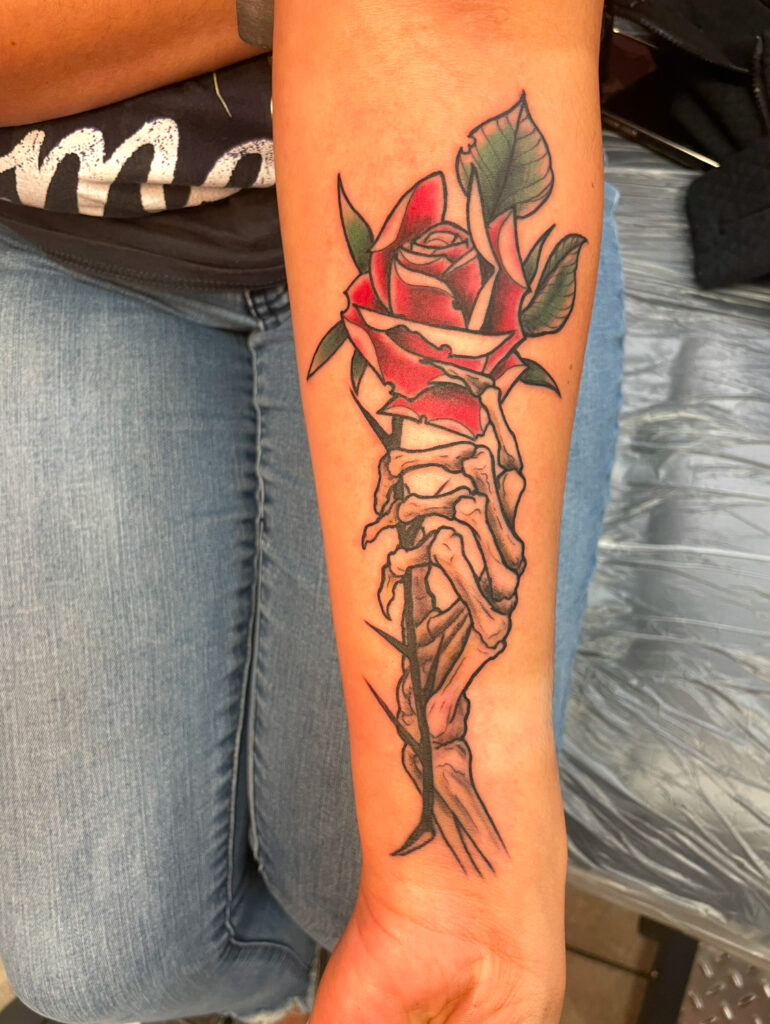 Rose and skeleton hand tattooed by Colton at the best tattoo shop in Katy, Texas at Artistic Impressions Tattoo Studio.